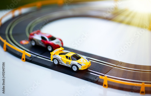 Toy cars go in a circle. Riding a race. The racing car surges forward.Car racing. Children's cars on the highway. photo