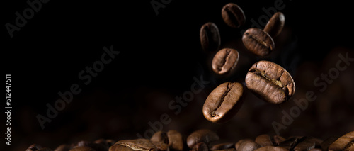 Foto Brown Roasted Coffee Beans Close- up On Dark Background.
