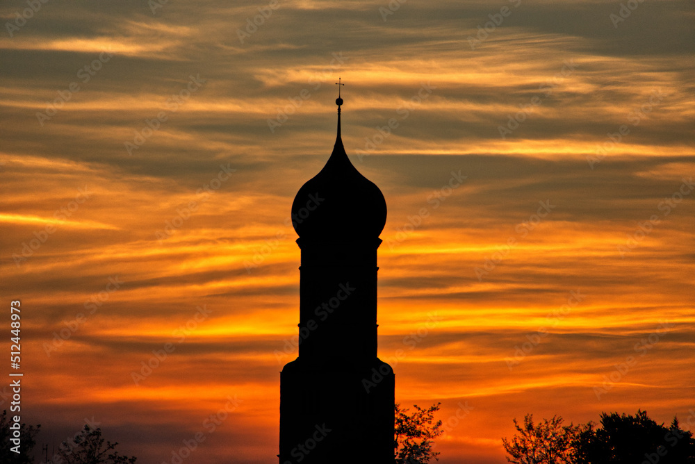 Church tower silhouette on a beautiful orange red sunset 
