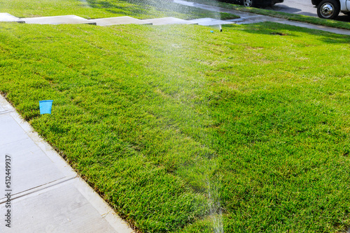 Spraying water on the lawn in very hot weather in lawn irrigation system