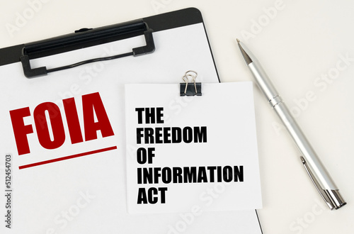 On the tablet, a sheet of paper and stickers with the inscription - FOIA, THE FREEDOM OF INFORMATION ACT photo