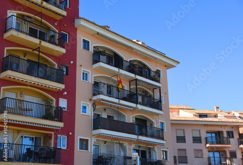 Facade building. Residential building with balconies and windows. Colorful apartment house. House with window and balcony. Buildings architecture and home facade. Modern minimalistic architecture. © MaxSafaniuk