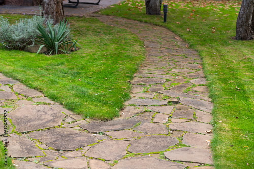 Obraz premium Pathway of natural stone in landscape design in the park