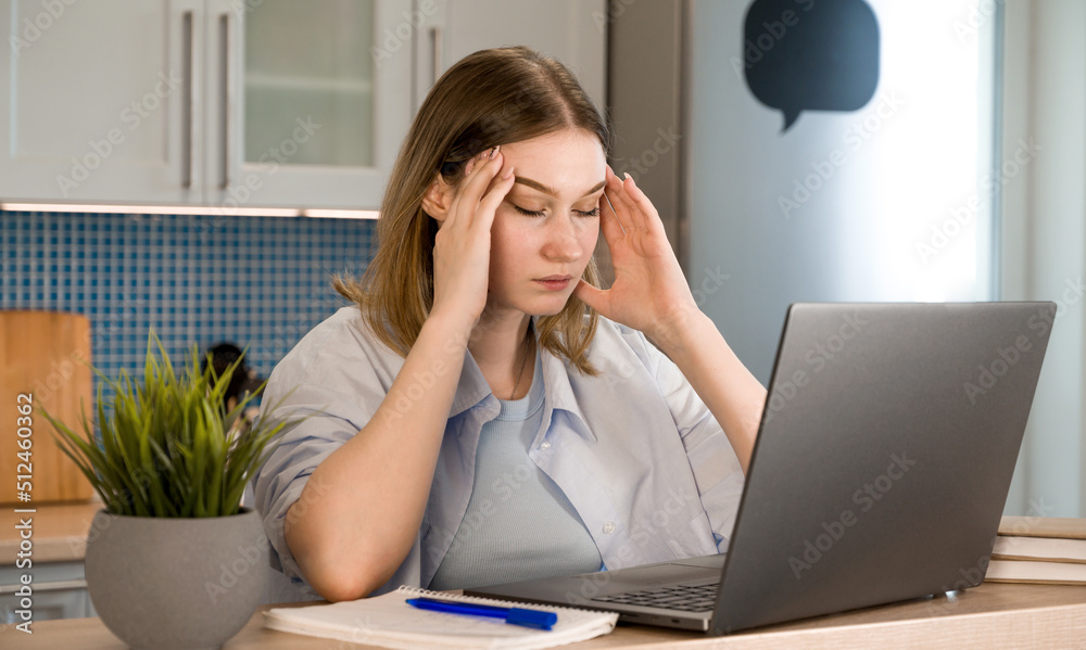 Closeup of a tired female sitting in front of laptop.Student tired bored with learning.Woman exhausted from work.Burnout,stressful enivironment Closeup of a tired female sitting in front of laptop.Student tired bored with learning.Woman exhausted from work.Burnout,stressful enivironment