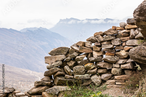 Ancient stones of old houses. Stone ruined wall. Panoramic mountain view © Inna