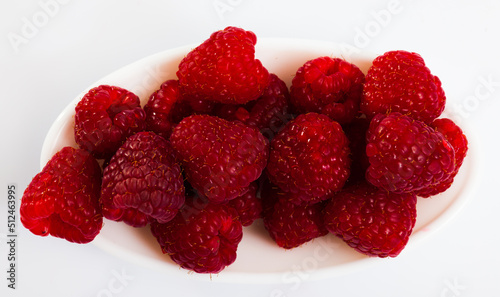 Close up of fresh tasty red raspberries on white background, nobody