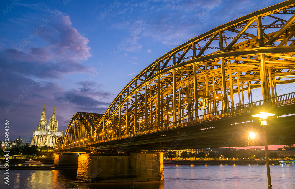 Fototapeta premium Cologne Cathedral and Hohenzollern Bridge at twilight, Germany