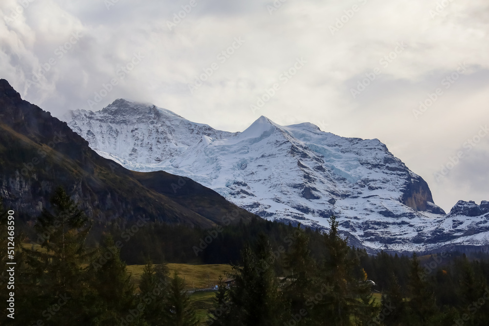 View of alp mountain in autumn have snow on top hill