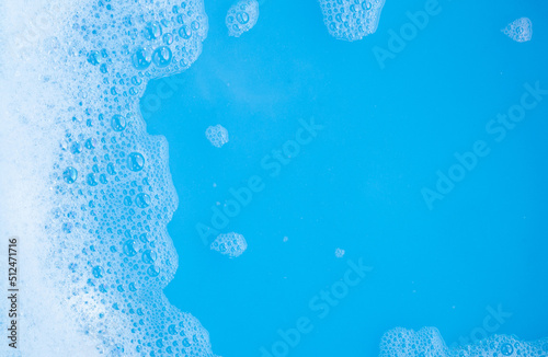 Detergent foam bubble, blue background.