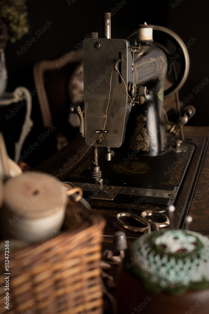 Fototapeta premium An antique 1880s sewing machine and vintage sewing equipment