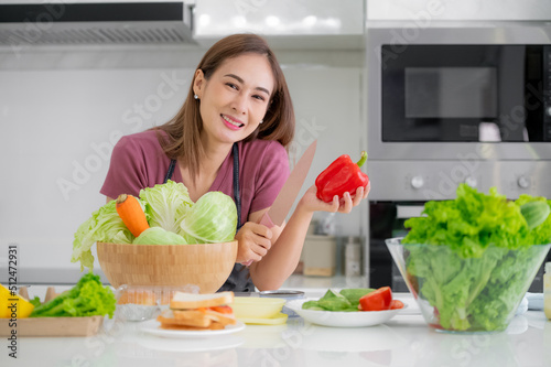 Asian women smiling in kitchen cooking salad vegetable eat healthy