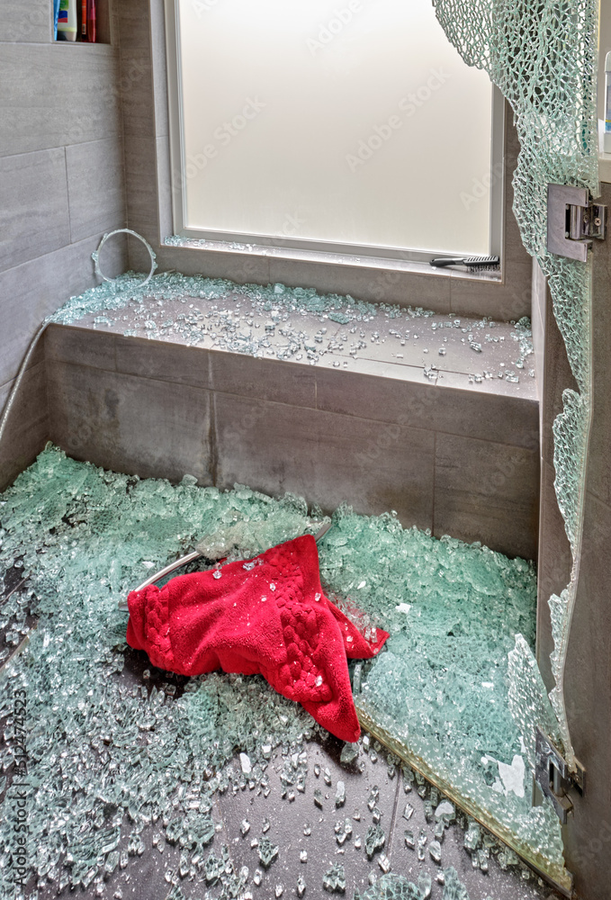 Shattered glass covers the shower floor after the door exploded