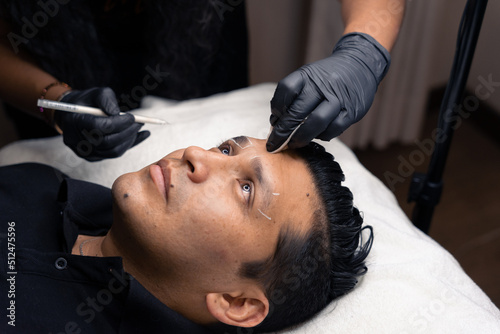 closeup of a man's eyebrow contour cleaning