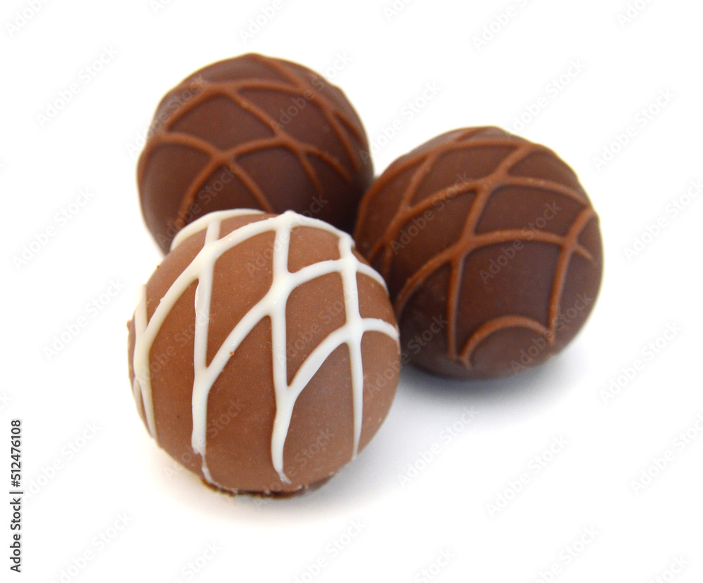 Fototapeta premium Chocolate candies collection. Beautiful Belgian truffles isolated on white background