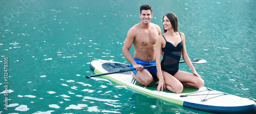 Young couple using paddle b...
