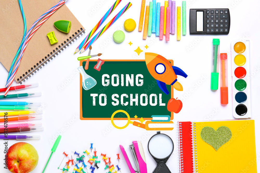 Drawn chalkboard with text GOING TO SCHOOL and set of stationery on white background Drawn chalkboard with text GOING TO SCHOOL and set of stationery on white background