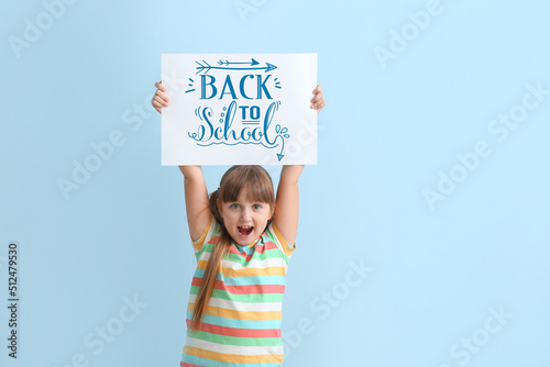 Happy little girl holding p...