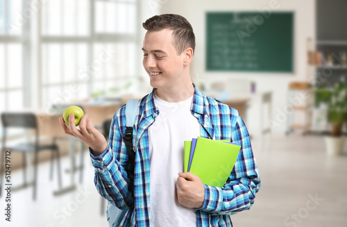 Male student with apple in ...