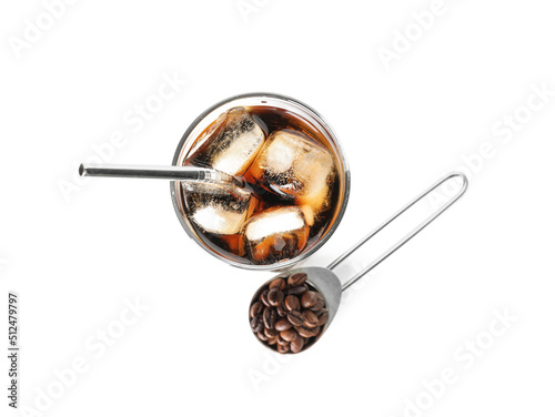 Glass of cold brew with straw and spoon with coffee beans on white background