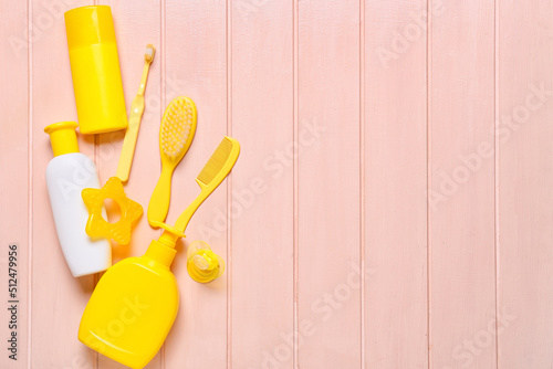 Bath accessories for baby on pink wooden background