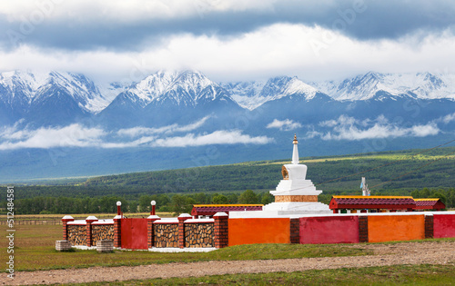 The Buddhist Stupa of Enlightenment against the backdrop of the snow-capped mountain peaks of the Eastern Sayan Mountains in the Tunka Valley of Buryatia on the way to the highland resort of Arshan photo