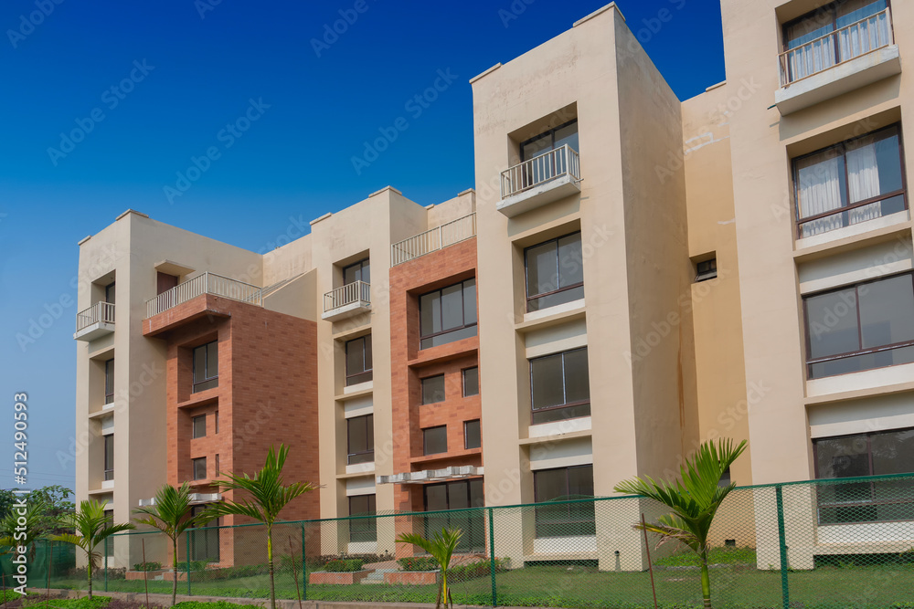 New residential building complex being built at Rajarhat New Town area of Kolkata, West Bengal, India. It is one of the fastest growing cities in eastern region of India. Blue sky background.