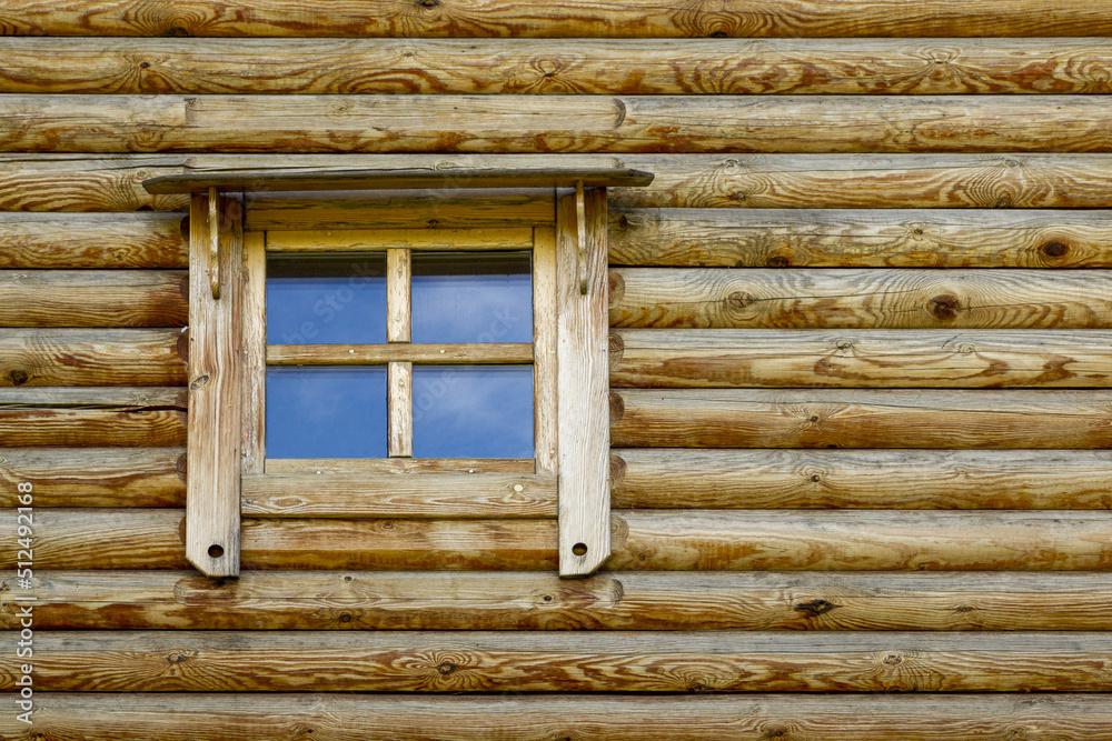 Background in the form of a fragment of an authentic wooden house in the form of a window with a wooden frame. Background in the form of a fragment of an authentic wooden house in the form of a window with a wooden frame.