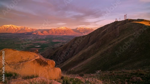 Sunset timelapse as light moves over mountain range from other mountain top in Utah. photo