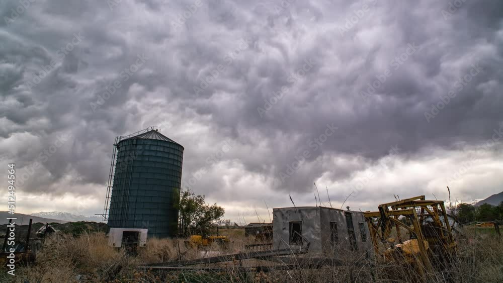Timelapse of odd clouds moving over old farm equipment during storm in Utah. Timelapse of odd clouds moving over old farm equipment during storm in Utah.