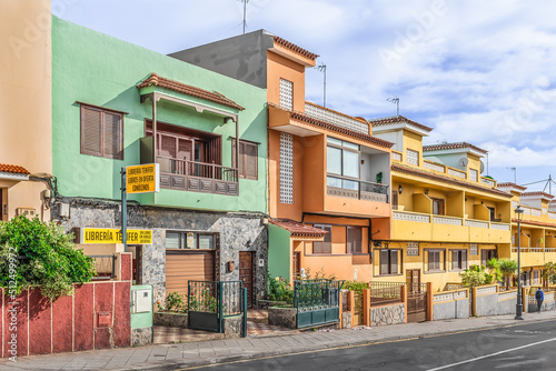San Cristobal de La Laguna, Spain - November 24, 2021: Bright old buildings on Calle Pedro Zerolo street in La Laguna town on the Tenerife island. Colorful cityscape in the Canary Islands
