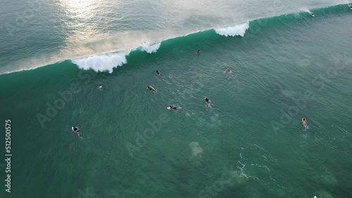 Close-out wave break quickly and surfers can not ride it, aerial shot of surf zone near Dreamland beach at evening time. People learn surfing, enjoy water sports, South Kuta shore of Bali island photo