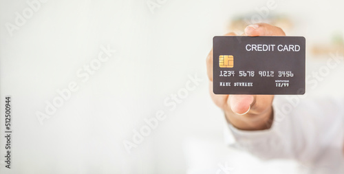 Hand of a man holding credit card.