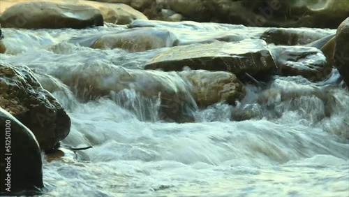 Rapids in a rocky mountain river, water descends over rocks