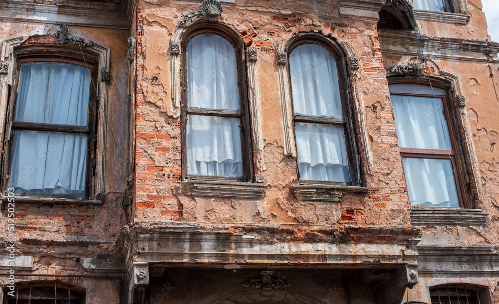 old cracked brick wall with a window. architecture, details. old cracked brick wall with a window. architecture, details.