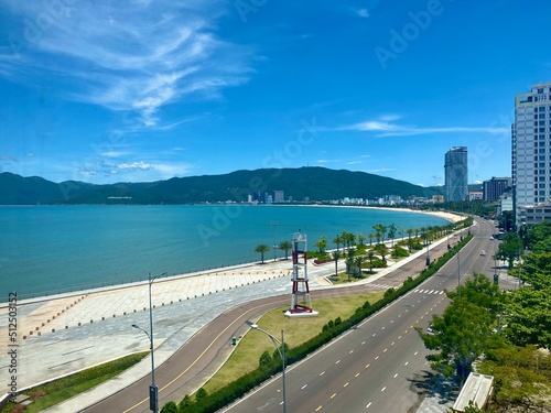 View of Quy Nhon city with a beautiful beach, long coastal route, clear blue sky, and high-rise hotels. Vietnam. Beautiful scenery in Vietnam
