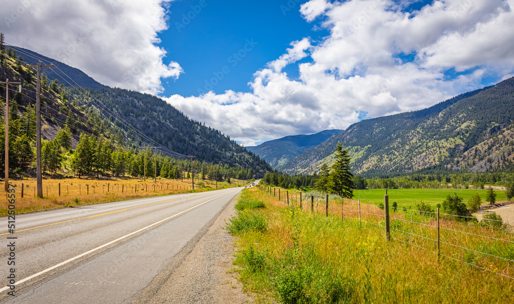 Empty asphalt highway and green mountain nature landscape at sunny summer day