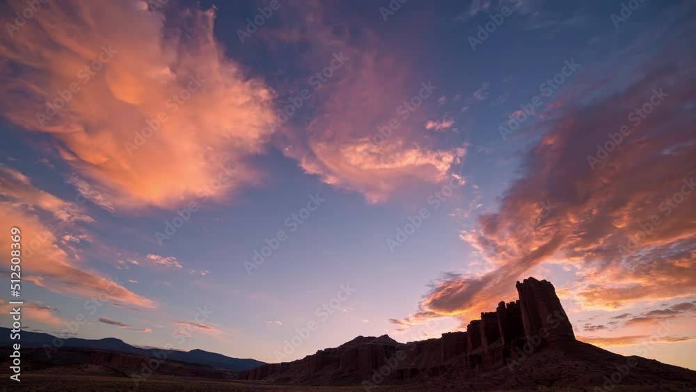 Time lapse of colorful desert time lapse in Utah as the clouds and sky change vibrant colors.