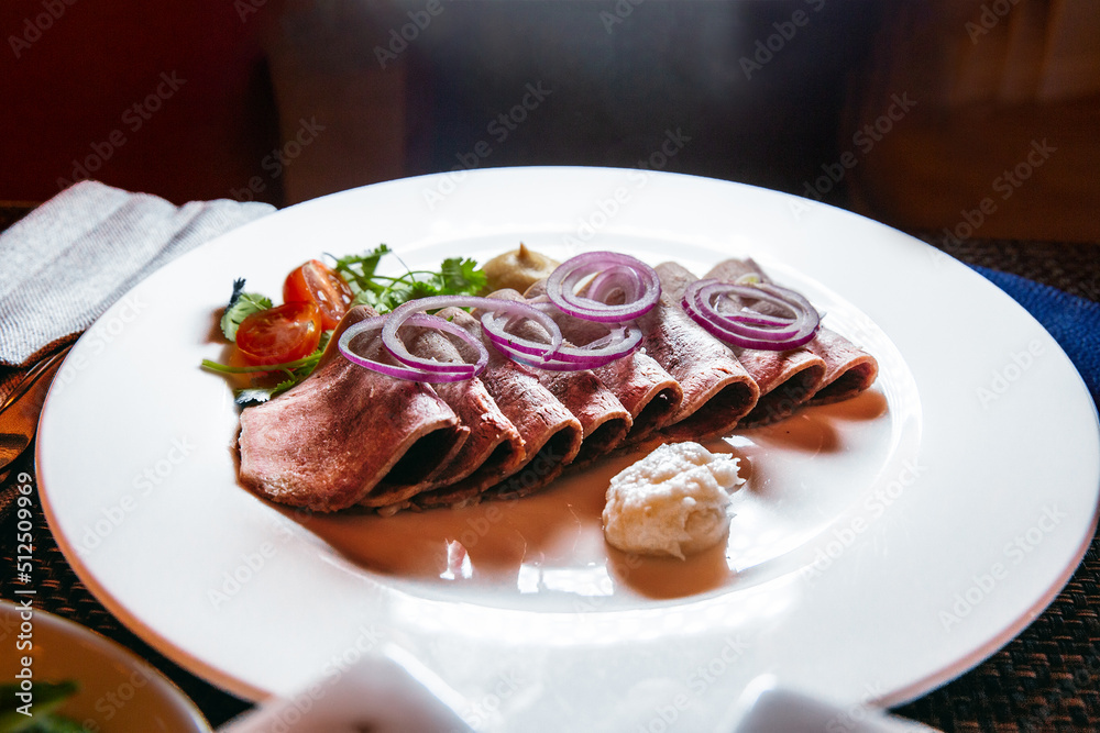 Sliced meat with onion rings, parsley, tomatoes, mustard and grated horseradish Sliced meat with onion rings, parsley, tomatoes, mustard and grated horseradish
