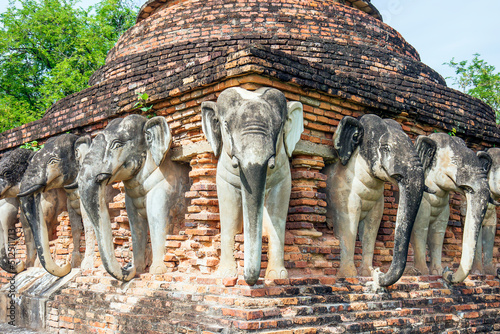 Fototapeta June 6, 2022, Sukhothai : Statue of elephants surrounded pagoda at Wat Sorasak,Temple in Sukhothai Historical Park, Sukhothai province,Thailand