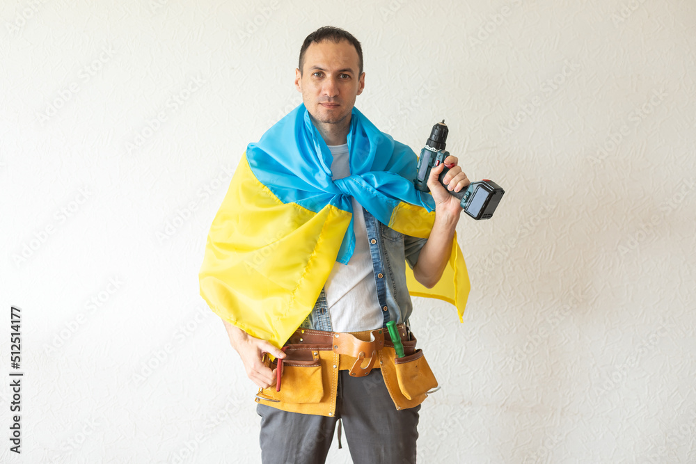 male repairman with the flag of Ukraine male repairman with the flag of Ukraine