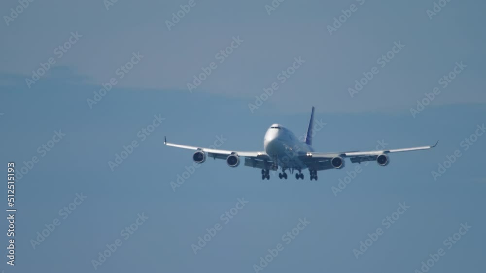 Wide body airliner descending for landing at Phuket Airport. Passenger jumbo jet flies. Tourism and travel concept Wide body airliner descending for landing at Phuket Airport. Passenger jumbo jet flies. Tourism and travel concept