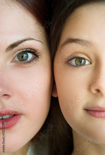 close up psychological portrait of mother and daughter on black background in studio 