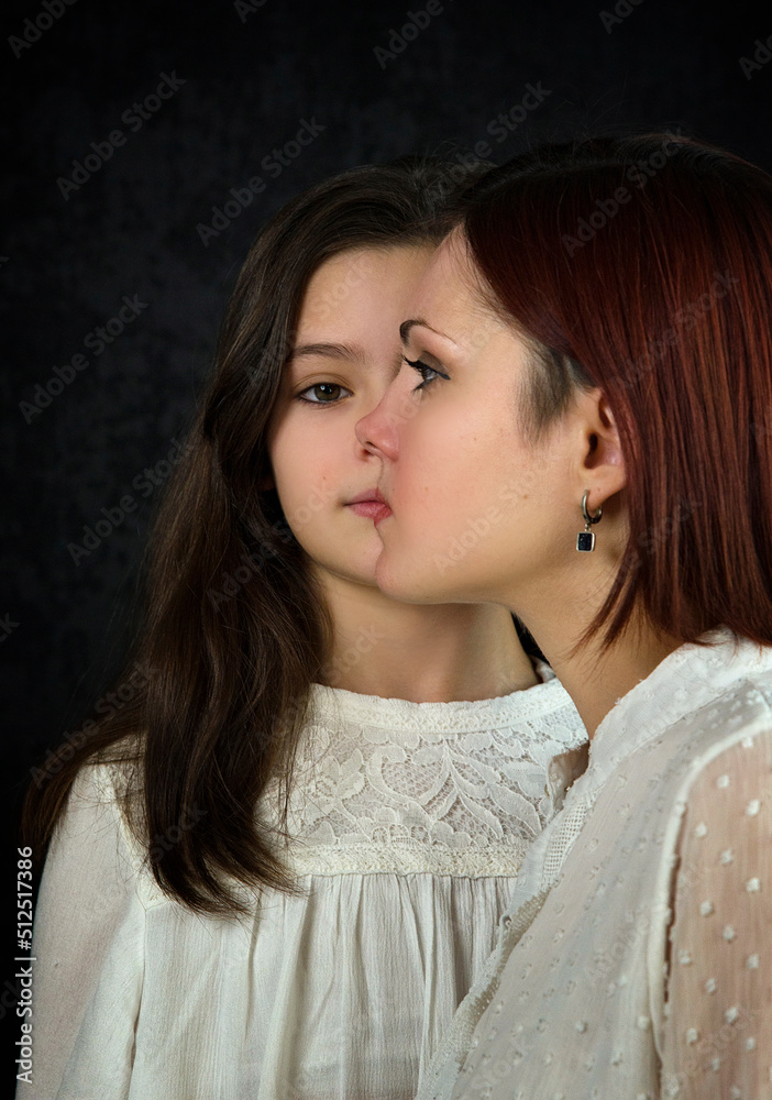 psychological portrait of mother and daughter on black background in