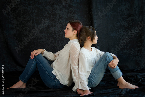 psychological portrait of mother and daughter on black background in studio. toxic mother-daughter relationship