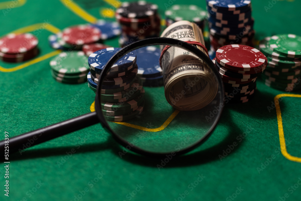 play cards, poker chips, money, with magnifying glass play cards, poker chips, money, with magnifying glass