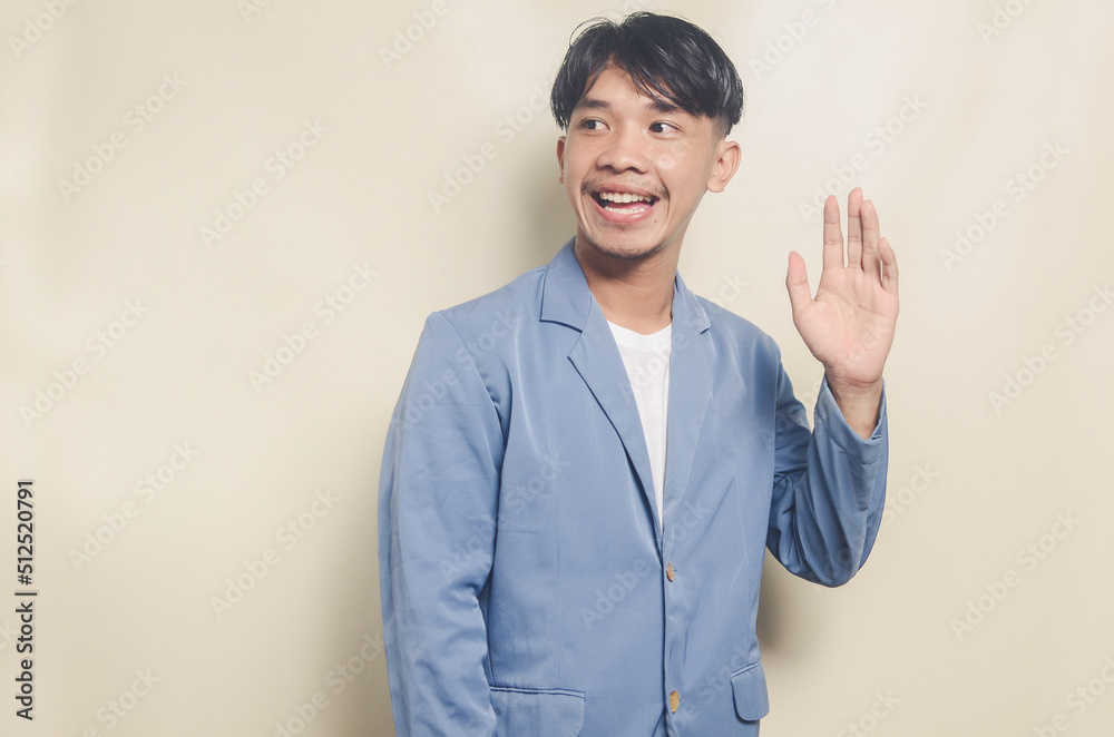 young asian man wearing college suit with greeting expression on isolated background young asian man wearing college suit with greeting expression on isolated background