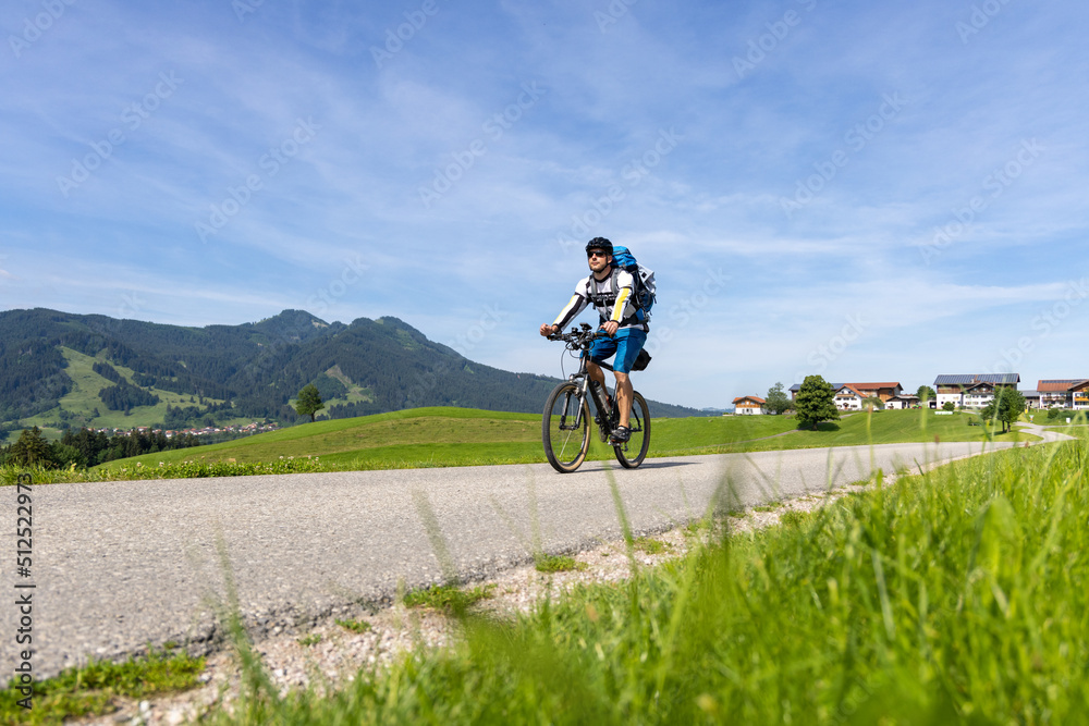 Cyclist on a bike tour in the southern Bavarian mountains