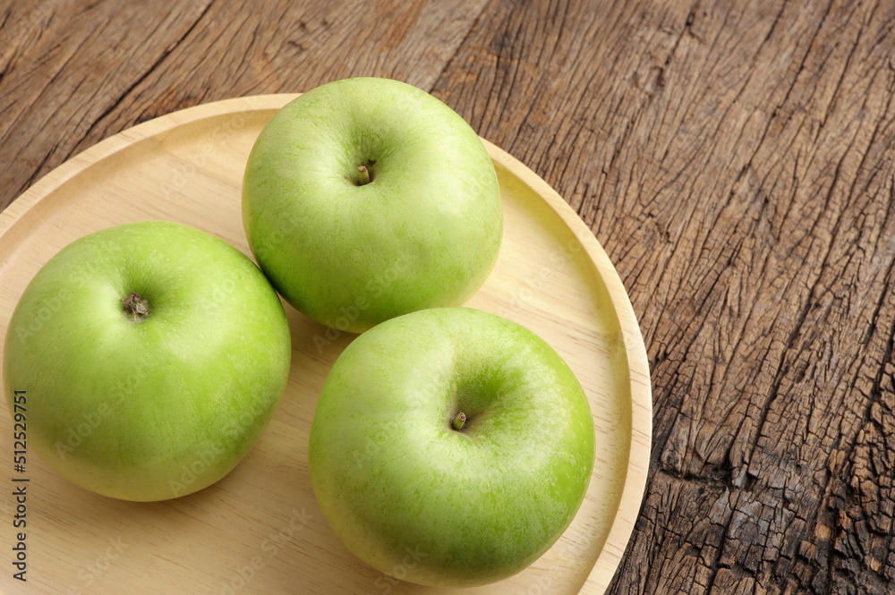 Green apples. Fresh ripe green apple on wooden plate. Green apples. Fresh ripe green apple on wooden plate.