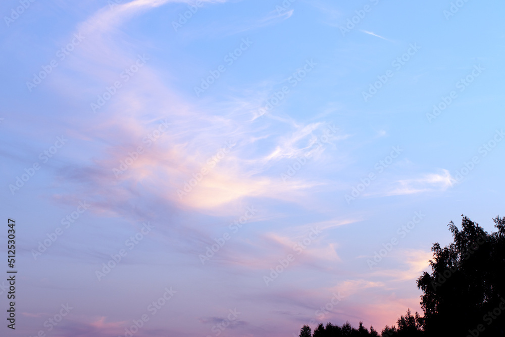 Romantic sunset sky yellow and blue colors with white clouds. Sunset light colors clouds in red, blue, pink and purple.