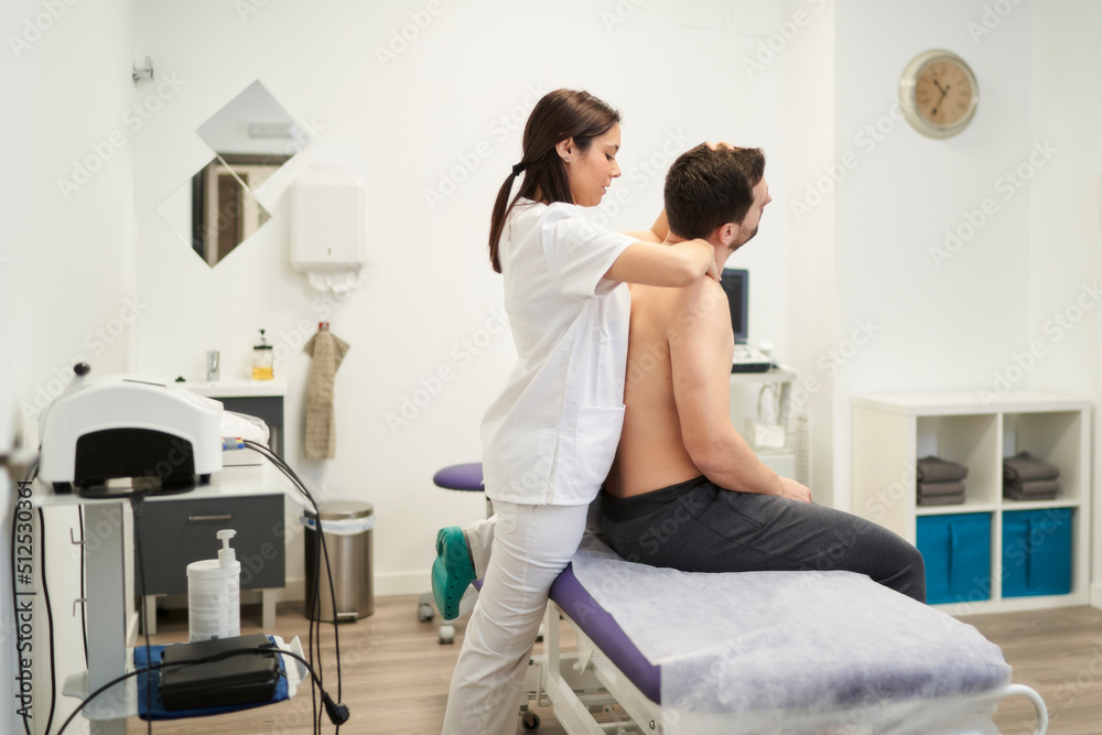 Fototapeta premium a man being treated for a spinal cord injury at the physiotherapist's office
